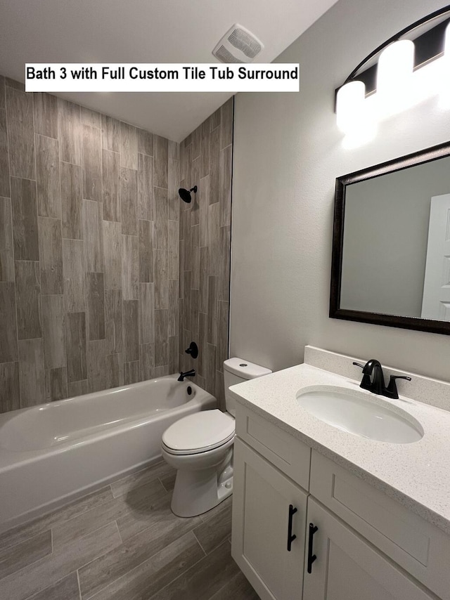 2675 Brodie Ln, Crestview, FL 32536 - full bath featuring toilet, vanity, shower / washtub combination, and wood finished floors