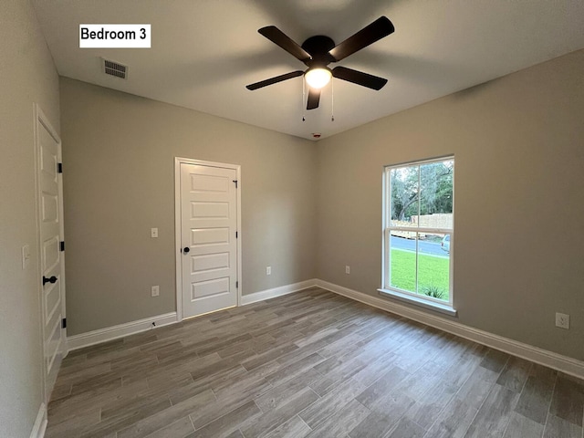 2675 Brodie Ln, Crestview, FL 32536 - unfurnished room with wood finished floors, ceiling fan, and baseboards