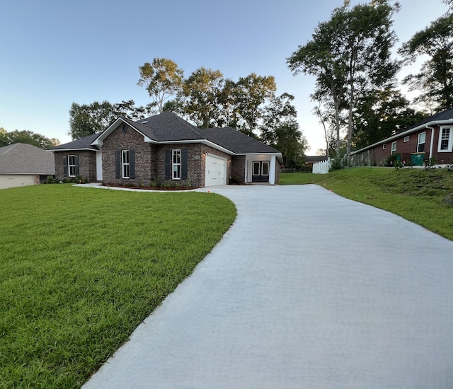 2675 Brodie Ln, Crestview, FL 32536 - ranch-style house with concrete driveway, a garage, a front yard, and brick siding