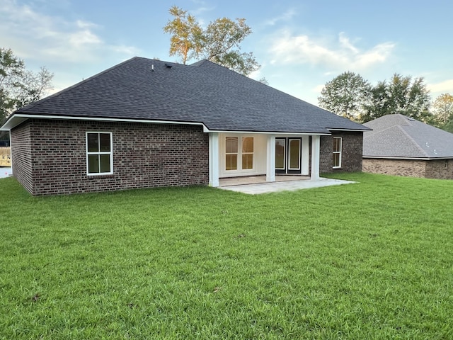 2675 Brodie Ln, Crestview, FL 32536 - rear view of house with roof with shingles, a patio, a yard, and brick siding