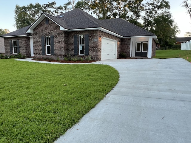 2675 Brodie Ln, Crestview, FL 32536 - view of front of property featuring brick siding, driveway, a front yard, an attached garage, and roof with shingles