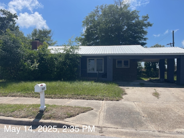 1217 Frankford Ave, Panama City, FL 32401 - view of front of property with a carport, concrete driveway, and metal roof