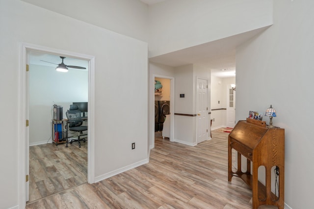 5420 Flag Tail Ln, Crestview, FL 32539 - hall featuring separate washer and dryer, an office area, light wood-style floors, and baseboards