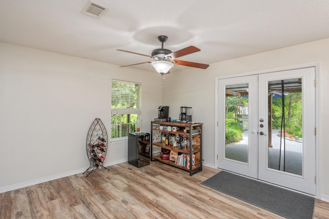 5420 Flag Tail Ln, Crestview, FL 32539 - entryway with french doors, light wood-type flooring, a ceiling fan, and baseboards