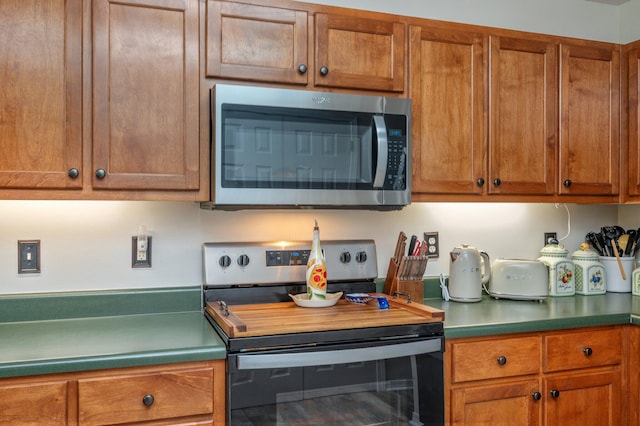 5420 Flag Tail Ln, Crestview, FL 32539 - kitchen with appliances with stainless steel finishes and brown cabinetry