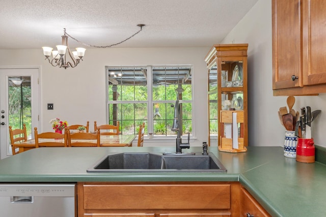 5420 Flag Tail Ln, Crestview, FL 32539 - kitchen with dishwasher, a sink, a textured ceiling, a chandelier, and brown cabinets
