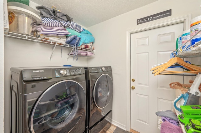 5420 Flag Tail Ln, Crestview, FL 32539 - laundry room featuring washer and clothes dryer, a textured ceiling, and wood finished floors