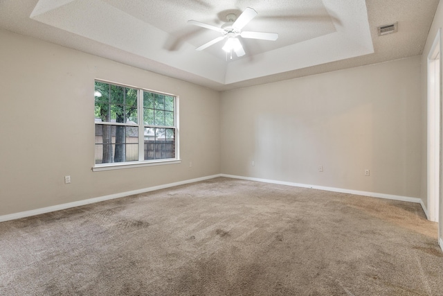 209 Warrior St, Crestview, FL 32536 - carpeted spare room featuring a tray ceiling, a ceiling fan, a textured ceiling, and baseboards