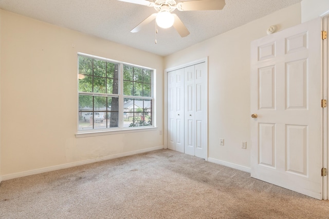 209 Warrior St, Crestview, FL 32536 - unfurnished bedroom with carpet flooring, a closet, baseboards, a textured ceiling, and ceiling fan