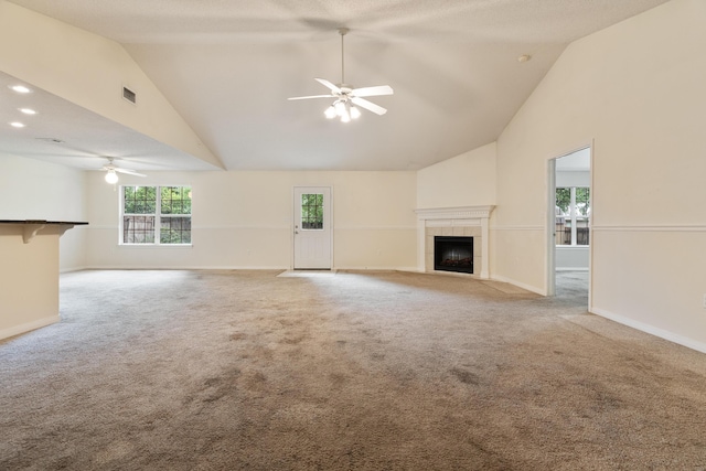 209 Warrior St, Crestview, FL 32536 - unfurnished living room featuring ceiling fan, a tile fireplace, high vaulted ceiling, light colored carpet, and baseboards