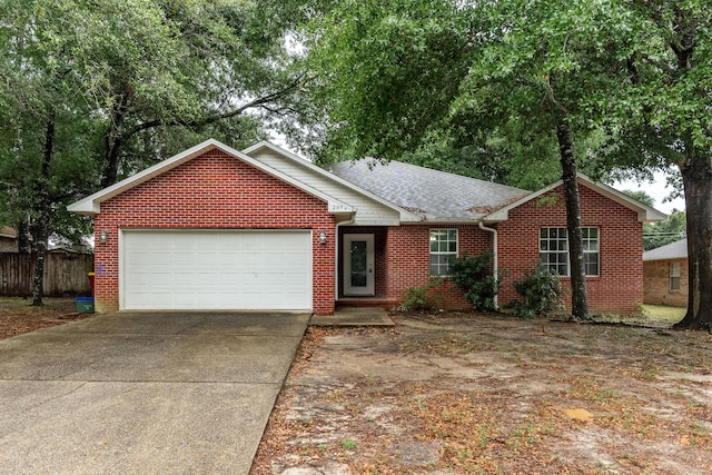 209 Warrior St, Crestview, FL 32536 - single story home featuring brick siding, concrete driveway, a garage, and a shingled roof