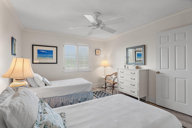5951 W Co Highway 30a 9 9, Santa Rosa Beach, FL 32459 - bedroom featuring ornamental molding, wood finished floors, baseboards, ceiling fan, and a textured ceiling