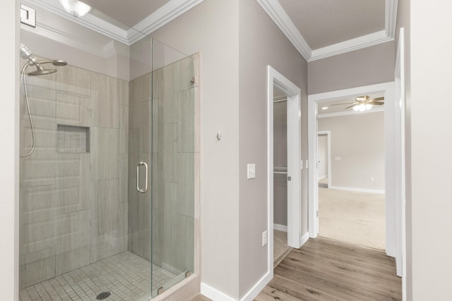 6437 Amanda Ct, Crestview, FL 32536 - full bathroom featuring crown molding, a stall shower, baseboards, wood finished floors, and ceiling fan