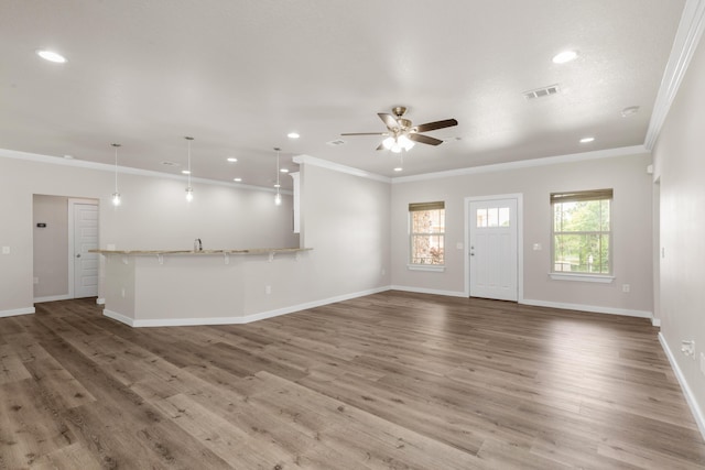 6437 Amanda Ct, Crestview, FL 32536 - unfurnished living room featuring crown molding, recessed lighting, ceiling fan, baseboards, and wood finished floors