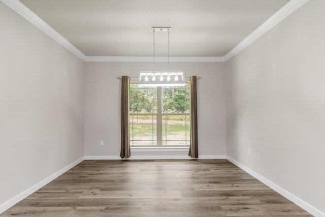 6437 Amanda Ct, Crestview, FL 32536 - empty room featuring ornamental molding, wood finished floors, baseboards, and a chandelier