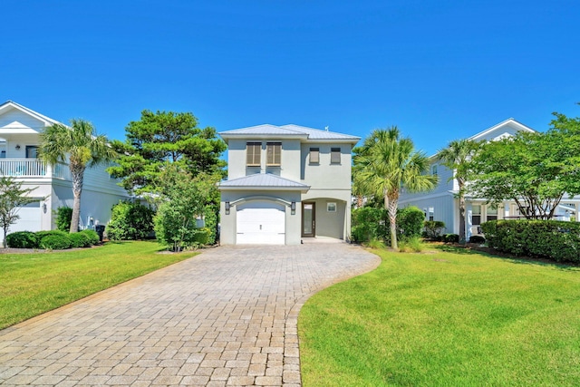 151 Penelope St, Miramar Beach, FL 32550 - beach home with a garage, decorative driveway, a front lawn, stucco siding, and metal roof