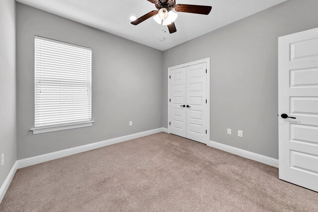 50 Oyster Blvd, Freeport, FL 32439 - unfurnished bedroom featuring carpet, baseboards, a closet, and a ceiling fan