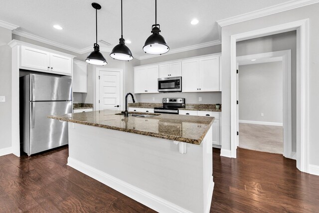 50 Oyster Blvd, Freeport, FL 32439 - kitchen with stainless steel appliances, a sink, a center island with sink, dark stone counters, and dark wood-type flooring