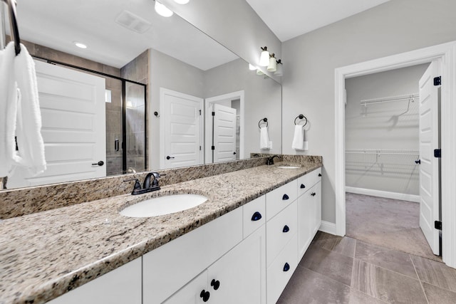 50 Oyster Blvd, Freeport, FL 32439 - full bath with double vanity, a shower stall, a spacious closet, and baseboards