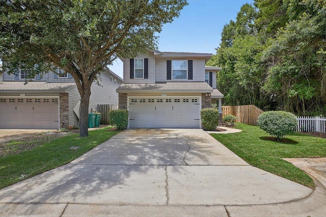 2909 Five Oaks Ln, Shalimar, FL 32579 - traditional home with stone siding, driveway, a garage, and a shingled roof