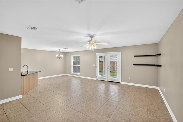 2909 Five Oaks Ln, Shalimar, FL 32579 - unfurnished living room with a ceiling fan, a chandelier, light tile patterned floors, and french doors