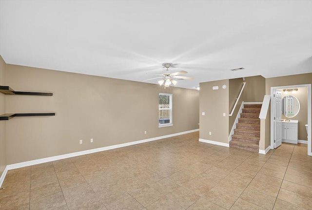 2909 Five Oaks Ln, Shalimar, FL 32579 - unfurnished living room with a ceiling fan, stairway, and light tile patterned floors