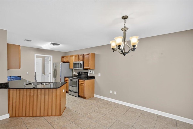 2909 Five Oaks Ln, Shalimar, FL 32579 - kitchen with stainless steel appliances, dark countertops, a chandelier, a peninsula, and light tile patterned floors