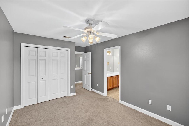 2909 Five Oaks Ln, Shalimar, FL 32579 - unfurnished bedroom featuring a closet, light colored carpet, a ceiling fan, and ensuite bathroom
