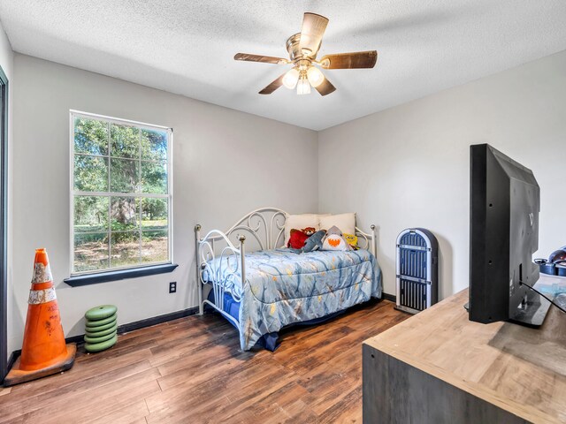 3241 Auburn Rd, Crestview, FL 32539 - bedroom featuring dark wood finished floors, ceiling fan, and a textured ceiling