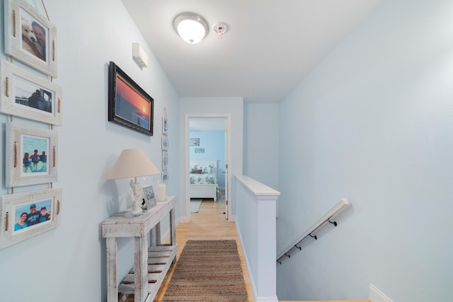 25 Misty Cv Unit 115, Miramar Beach, FL 32550 - corridor featuring an upstairs landing, light wood-style floors, and baseboards