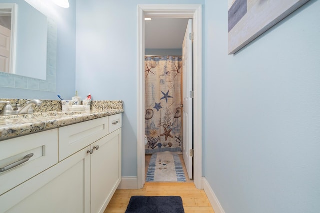 25 Misty Cv Unit 115, Miramar Beach, FL 32550 - bathroom featuring vanity, wood finished floors, and baseboards