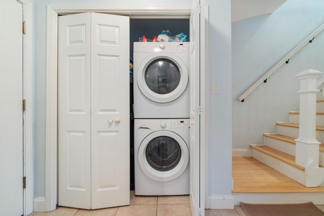 25 Misty Cv Unit 115, Miramar Beach, FL 32550 - washroom with stacked washing machine and dryer, light tile patterned floors, and baseboards