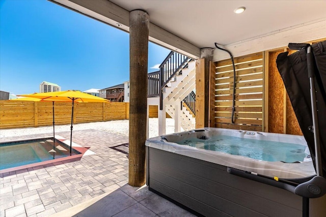 8169 White Sands Blvd, Navarre, FL 32566 - fenced backyard featuring stairs, a hot tub, a patio area, and a pool