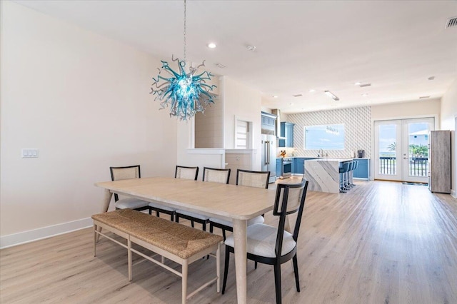 8169 White Sands Blvd, Navarre, FL 32566 - dining area with french doors, light wood finished floors, baseboards, and recessed lighting