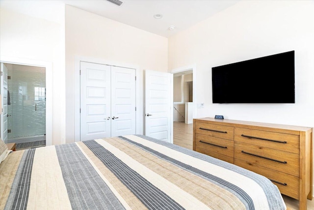 8169 White Sands Blvd, Navarre, FL 32566 - bedroom with a closet, connected bathroom, and light wood-style floors