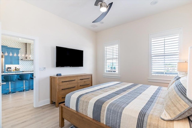 8169 White Sands Blvd, Navarre, FL 32566 - bedroom with light wood-style flooring and ceiling fan
