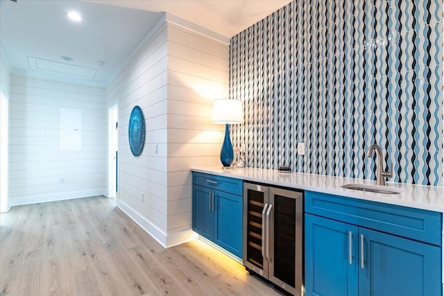 8169 White Sands Blvd, Navarre, FL 32566 - indoor wet bar with beverage cooler, light wood finished floors, baseboards, and wooden walls