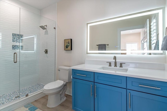 8169 White Sands Blvd, Navarre, FL 32566 - full bathroom featuring toilet, a shower stall, vanity, and wood finished floors