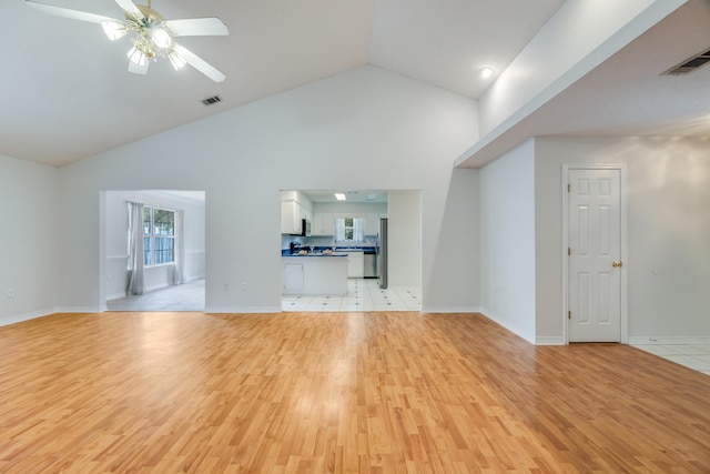 2803 Macgregor Ln, Crestview, FL 32539 - unfurnished living room with light wood-type flooring, a ceiling fan, high vaulted ceiling, and baseboards