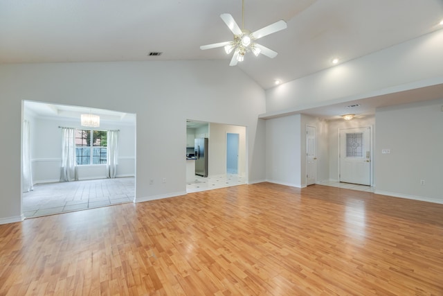 2803 Macgregor Ln, Crestview, FL 32539 - empty room featuring light wood-style flooring, high vaulted ceiling, a chandelier, ceiling fan, and baseboards