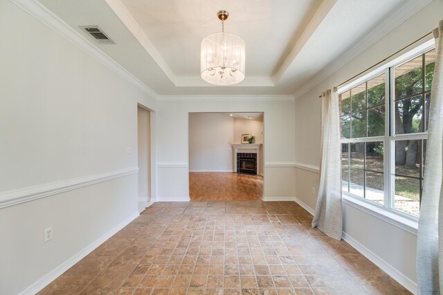 2803 Macgregor Ln, Crestview, FL 32539 - unfurnished room with healthy amount of natural light, a chandelier, a raised ceiling, and stone finish floors