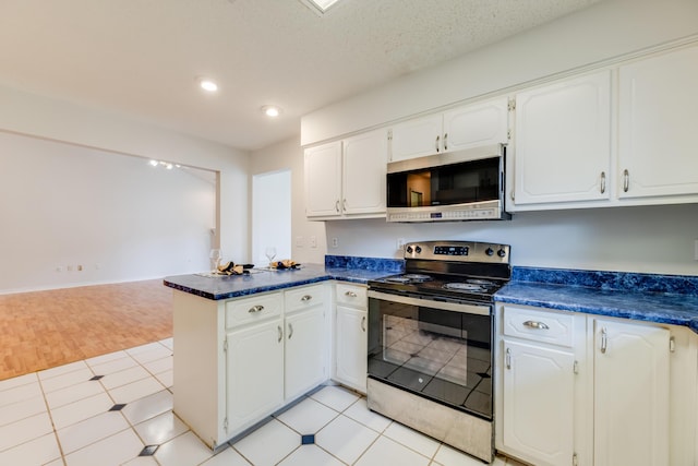 2803 Macgregor Ln, Crestview, FL 32539 - kitchen featuring stainless steel appliances, a peninsula, dark countertops, white cabinets, and recessed lighting