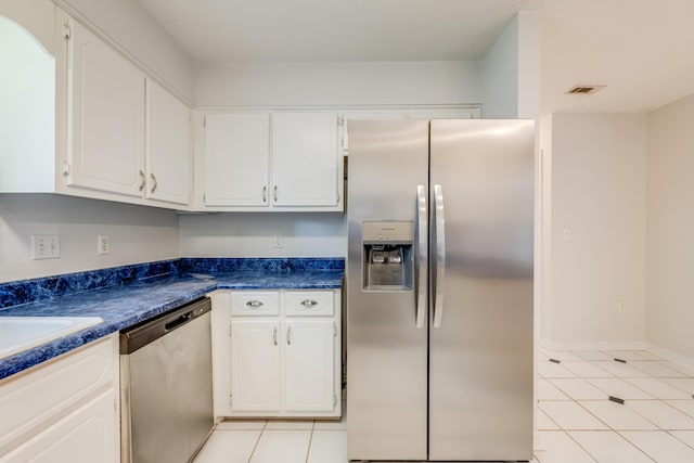 2803 Macgregor Ln, Crestview, FL 32539 - kitchen featuring appliances with stainless steel finishes, light tile patterned flooring, white cabinets, and dark countertops