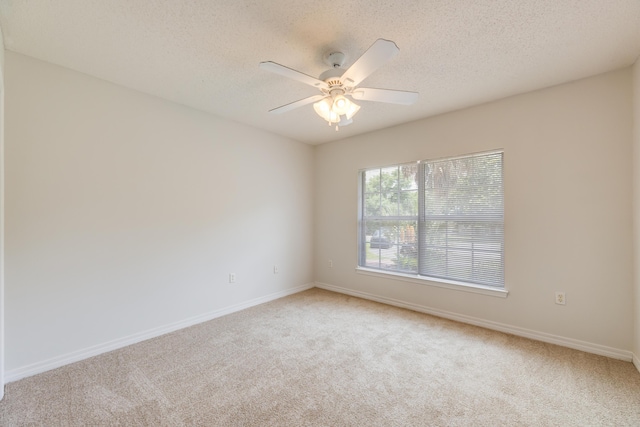 2803 Macgregor Ln, Crestview, FL 32539 - spare room featuring light carpet, a textured ceiling, baseboards, and a ceiling fan