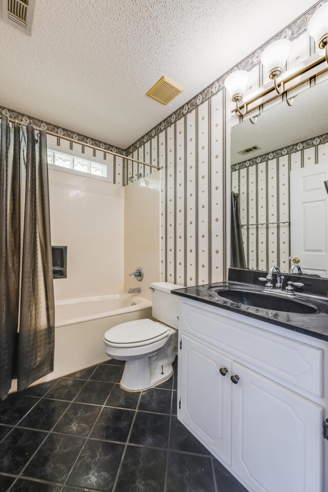 2803 Macgregor Ln, Crestview, FL 32539 - full bath with vanity, toilet, shower / bathtub combination, a textured ceiling, and tile patterned floors