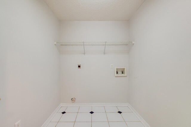2803 Macgregor Ln, Crestview, FL 32539 - laundry area featuring hookup for an electric dryer, washer hookup, baseboards, and tile patterned floors