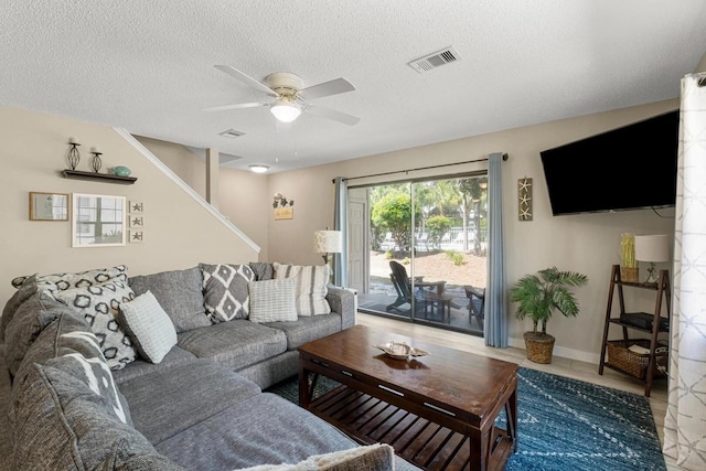 15 Cypress St Unit 268, Santa Rosa Beach, FL 32459 - living room featuring ceiling fan, a textured ceiling, and stairs