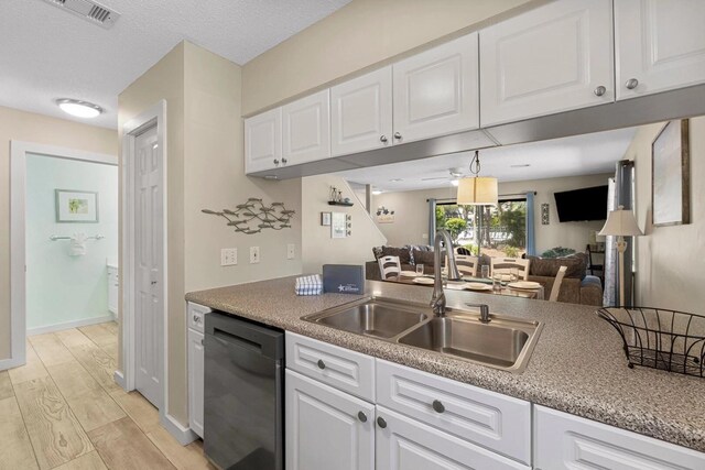 15 Cypress St Unit 268, Santa Rosa Beach, FL 32459 - kitchen featuring stainless steel dishwasher, a sink, light wood-style flooring, white cabinetry, and light countertops