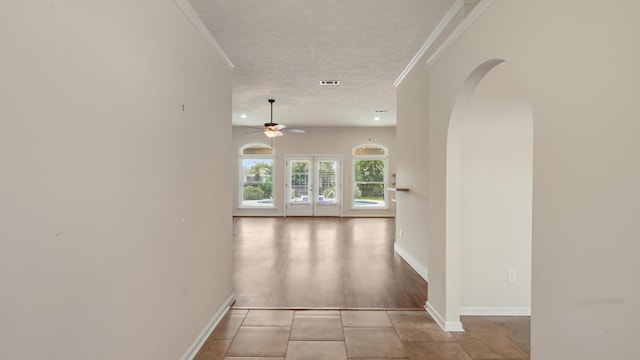 108 Colony Bay Harbour Dr, Panama City Beach, FL 32407 - corridor with arched walkways, ornamental molding, a textured ceiling, baseboards, and tile patterned flooring