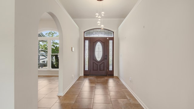 108 Colony Bay Harbour Dr, Panama City Beach, FL 32407 - foyer featuring plenty of natural light, ornamental molding, light tile patterned floors, and baseboards